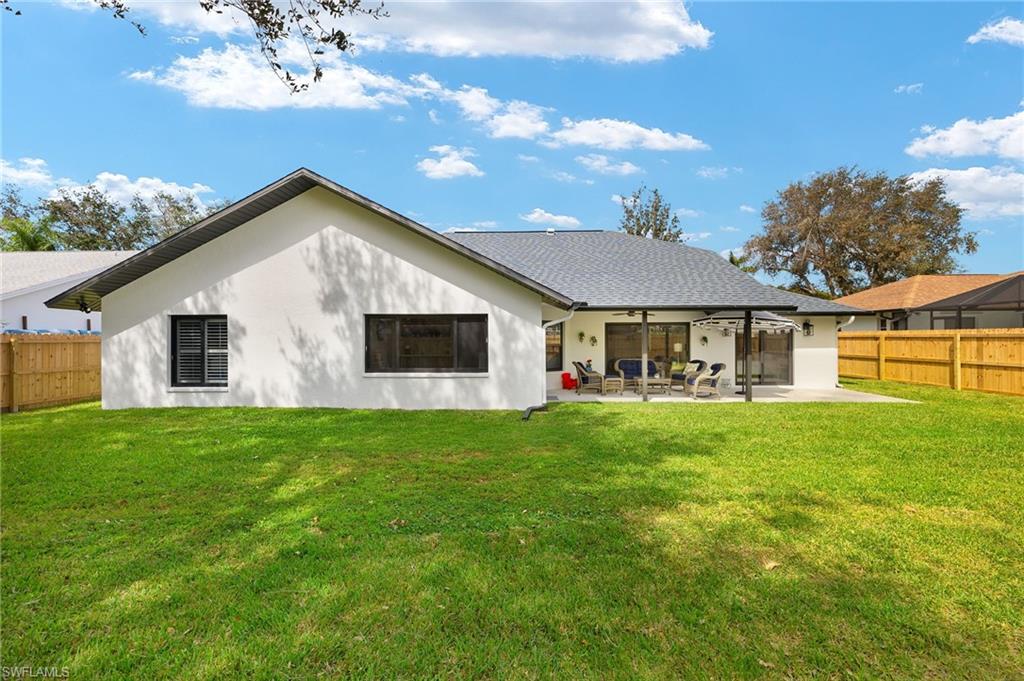 10274 Boca Circle Naples, FL 34109 - Photo 23 of 26 a front view of house with a garden