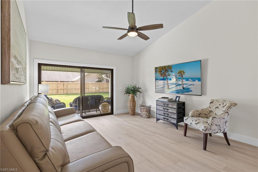 10274 Boca Circle Naples, FL 34109 - Photo 4 of 26 a living room with furniture and a large window