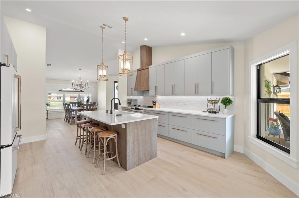 10274 Boca Circle Naples, FL 34109 - Photo 8 of 26 a kitchen with a sink stove and cabinets