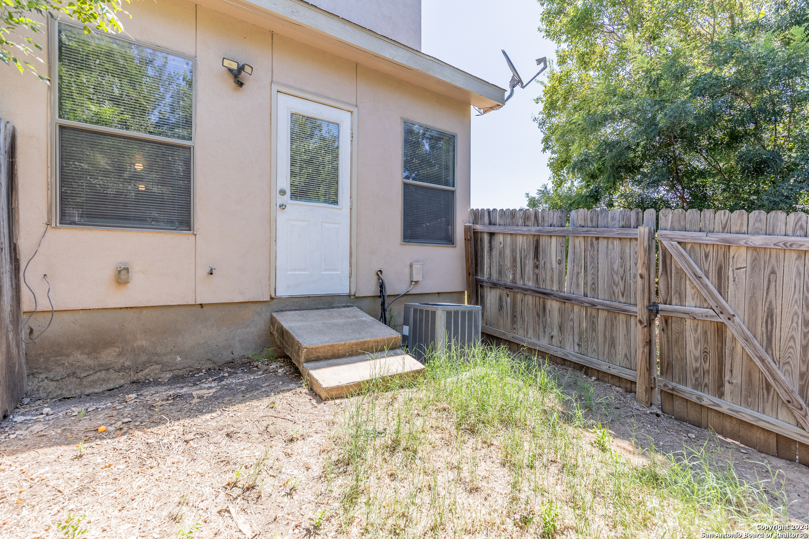 10711 Mathom Landing, Unit 1 Universal City, TX 78148 - Photo 8 of 31 a view of a backyard with wooden fence