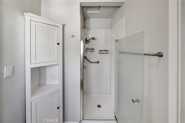a bathroom with a glass shower door and a sink