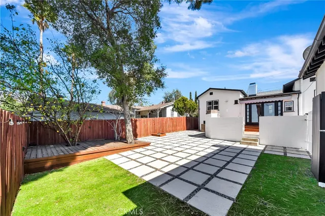 a view of a backyard with a that has a patio