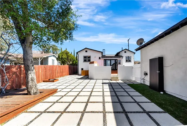 a view of a white house with a small yard