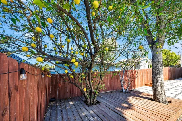 a view of balcony with wooden floor and fence