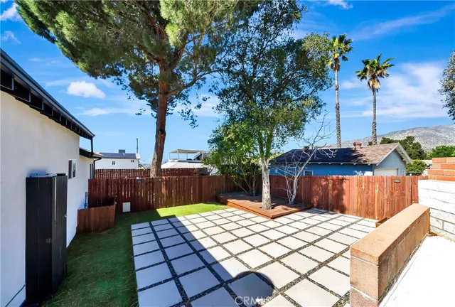 an aerial view of residential houses with outdoor space and parking