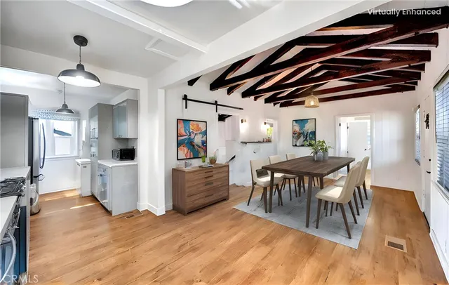 a view of a dining room with furniture and wooden floor