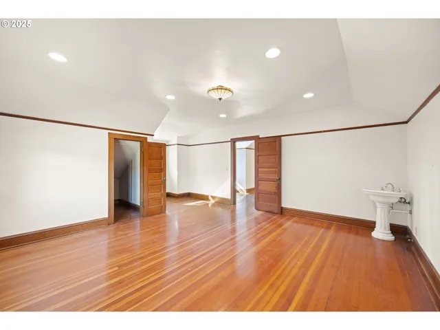 a view of a house with a big yard and large trees