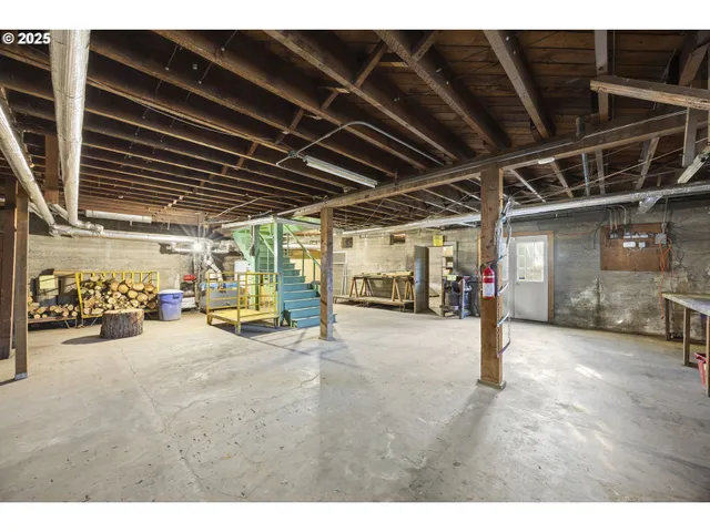 a view of a large pool with lawn chairs under an umbrella