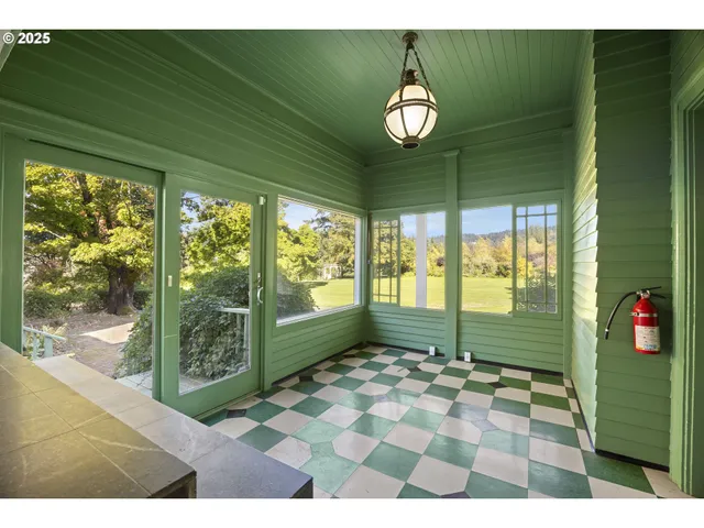a view of a hallway with wooden walls