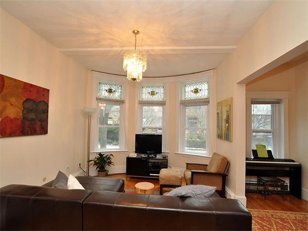 12 Kilsyth Road, Unit 1 Brookline, MA 02445 - Photo 1 of 9 a living room with fireplace furniture and a flat screen tv