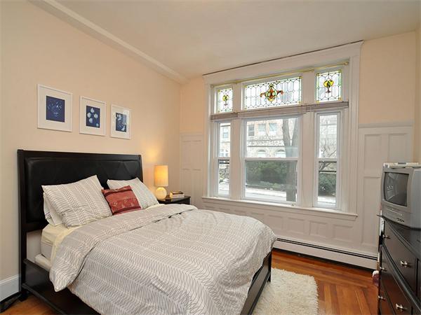 12 Kilsyth Road, Unit 1 Brookline, MA 02445 - Photo 4 of 9 a bedroom with a large bed and a flat tv screen