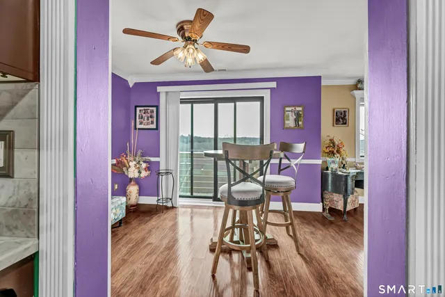 a view of a dining room with furniture window and wooden floor