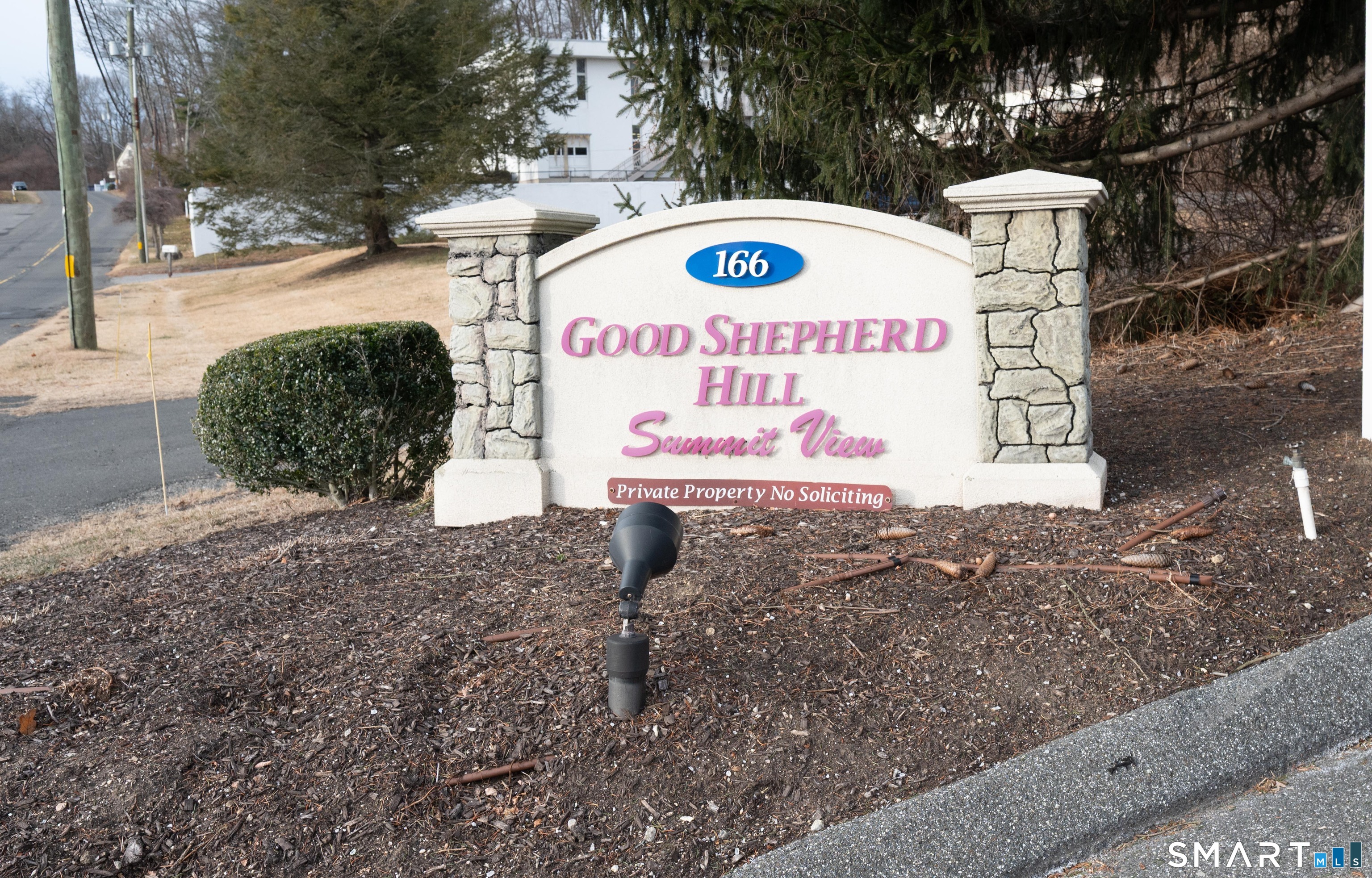 166 Old Brookfield Road, Unit 18A6 Danbury, CT 06811 - Photo 19 of 19 a sign on the side of the road