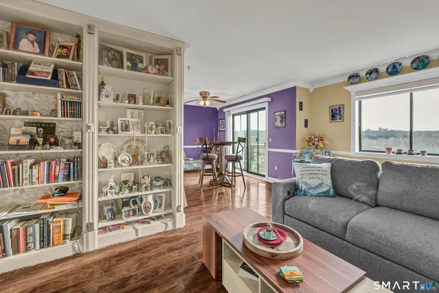 a living room with furniture and a book shelf