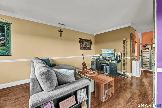 a living room with a couch and wooden floor