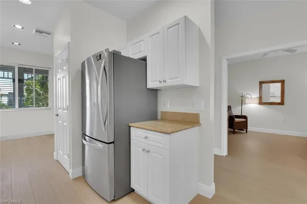 a kitchen with a refrigerator and a stove