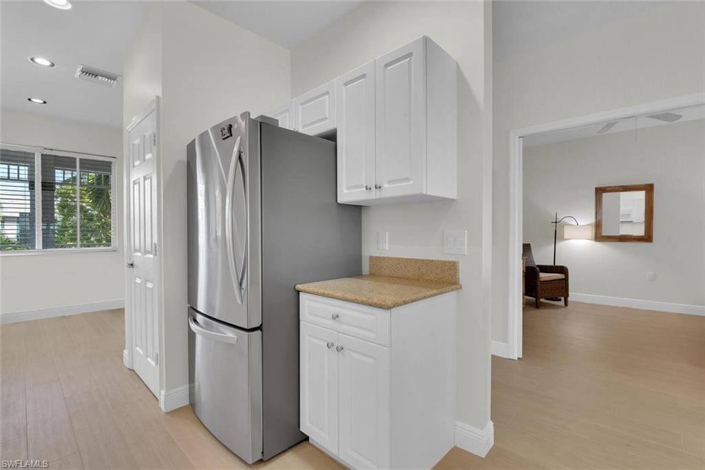 7925 Mahogany Run Lane, Unit 924 Naples, FL 34113 - Photo 12 of 40 a kitchen with a refrigerator and a stove