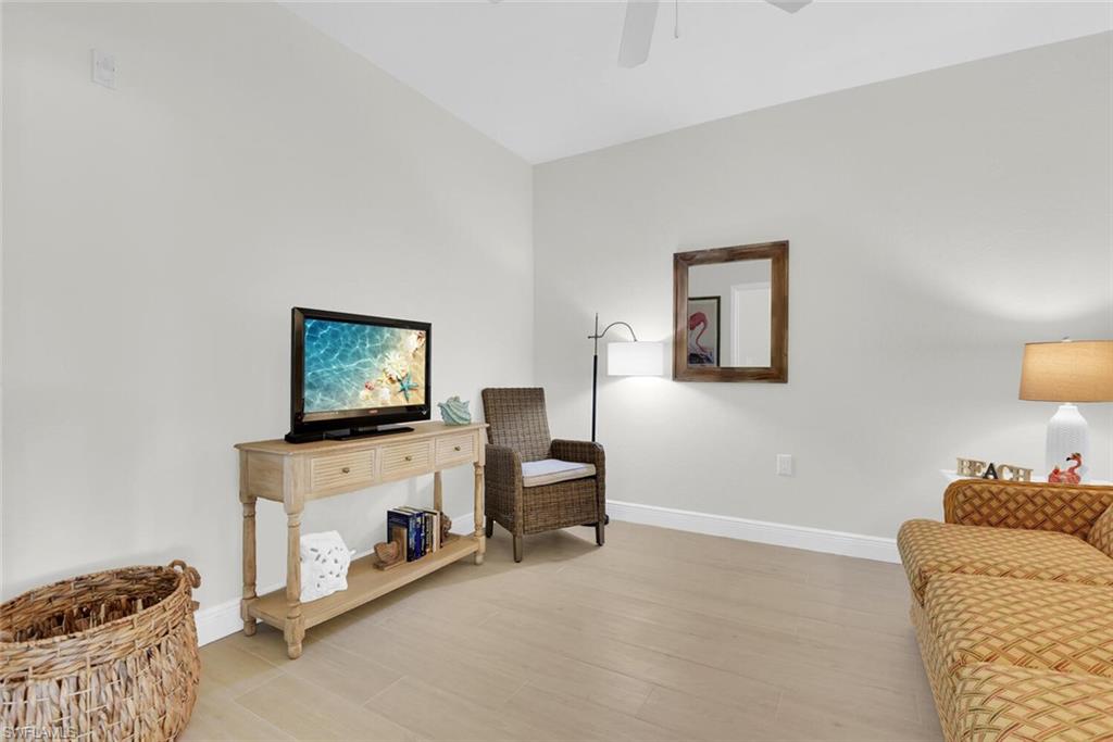 7925 Mahogany Run Lane, Unit 924 Naples, FL 34113 - Photo 16 of 40 a living room with furniture and a flat screen tv