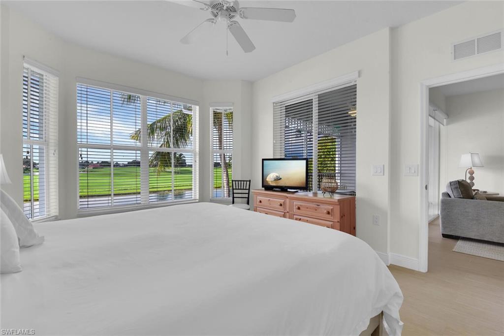 7925 Mahogany Run Lane, Unit 924 Naples, FL 34113 - Photo 18 of 40 a bedroom with furniture and a flat screen tv