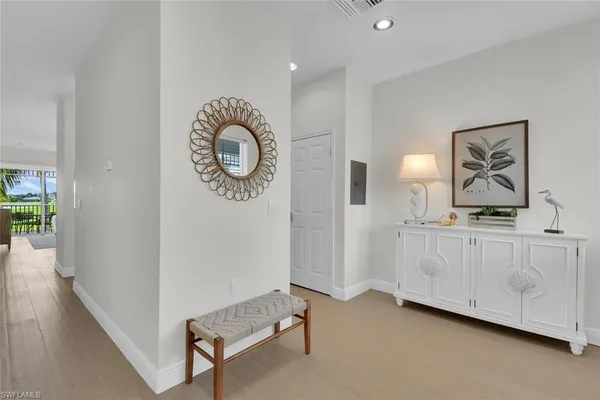 a view of a room with wooden floor and white walls