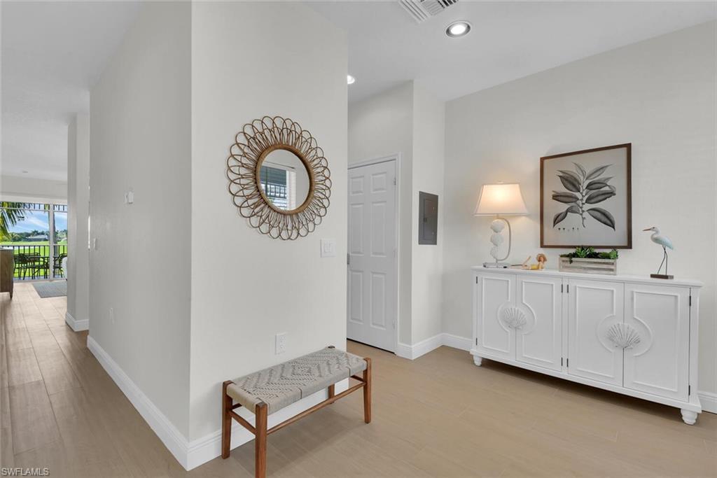 7925 Mahogany Run Lane, Unit 924 Naples, FL 34113 - Photo 2 of 40 a view of a room with wooden floor and white walls
