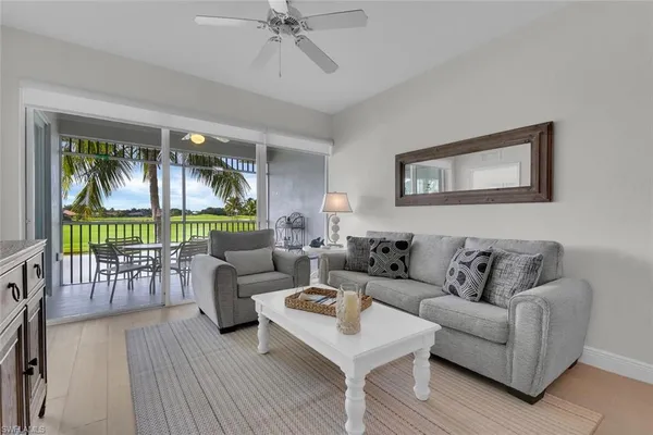 a living room with furniture and a large window