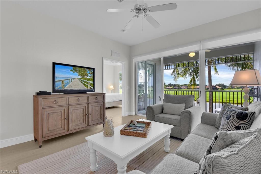 7925 Mahogany Run Lane, Unit 924 Naples, FL 34113 - Photo 5 of 40 a living room with furniture and a flat screen tv