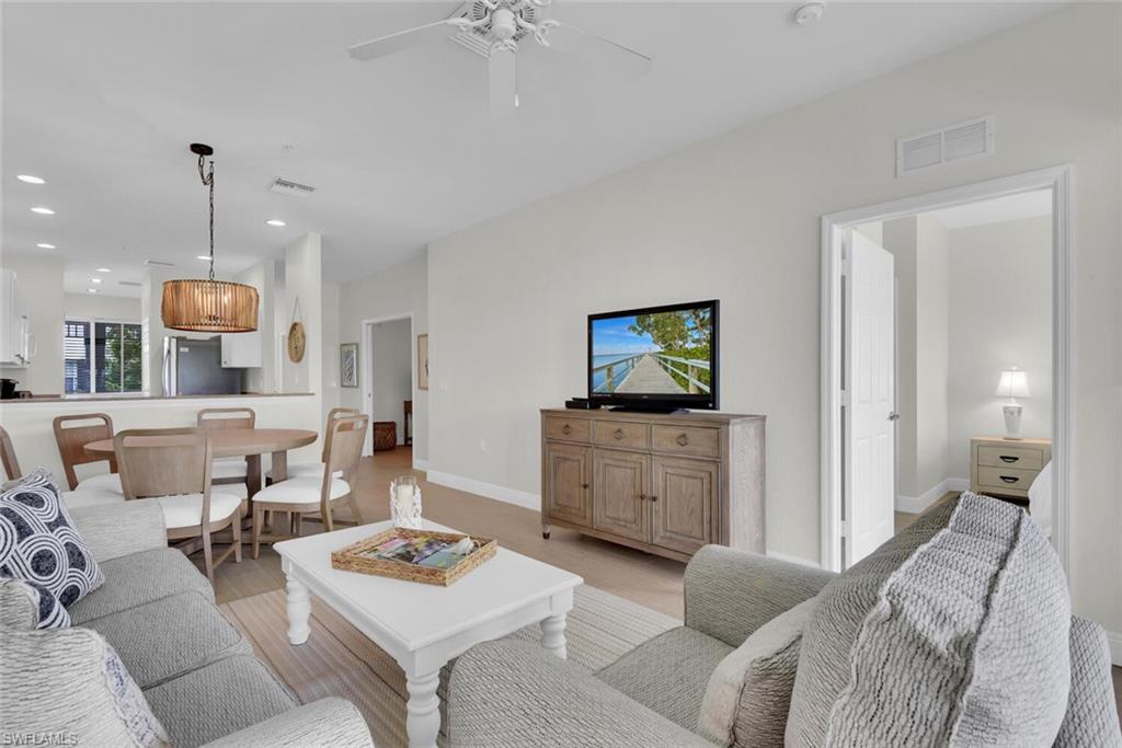 7925 Mahogany Run Lane, Unit 924 Naples, FL 34113 - Photo 7 of 40 a living room with furniture and a wooden floor
