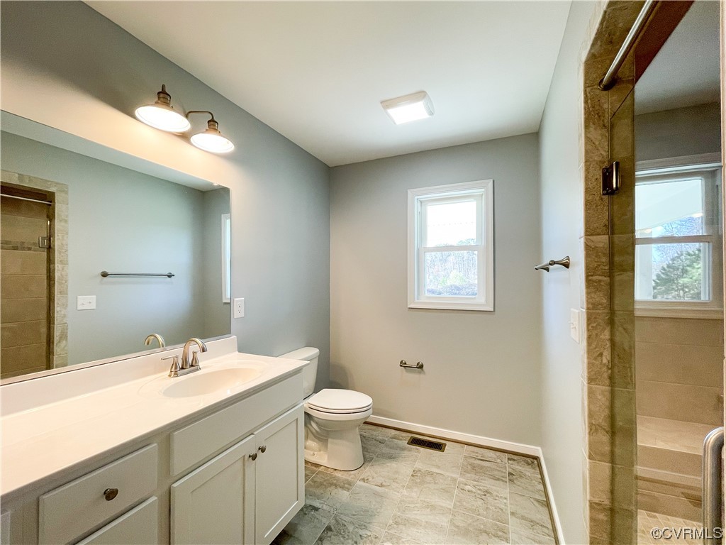 292 Wilson Road Blackstone, VA 23824 - Photo 25 of 48 a bathroom with a granite countertop sink toilet and shower