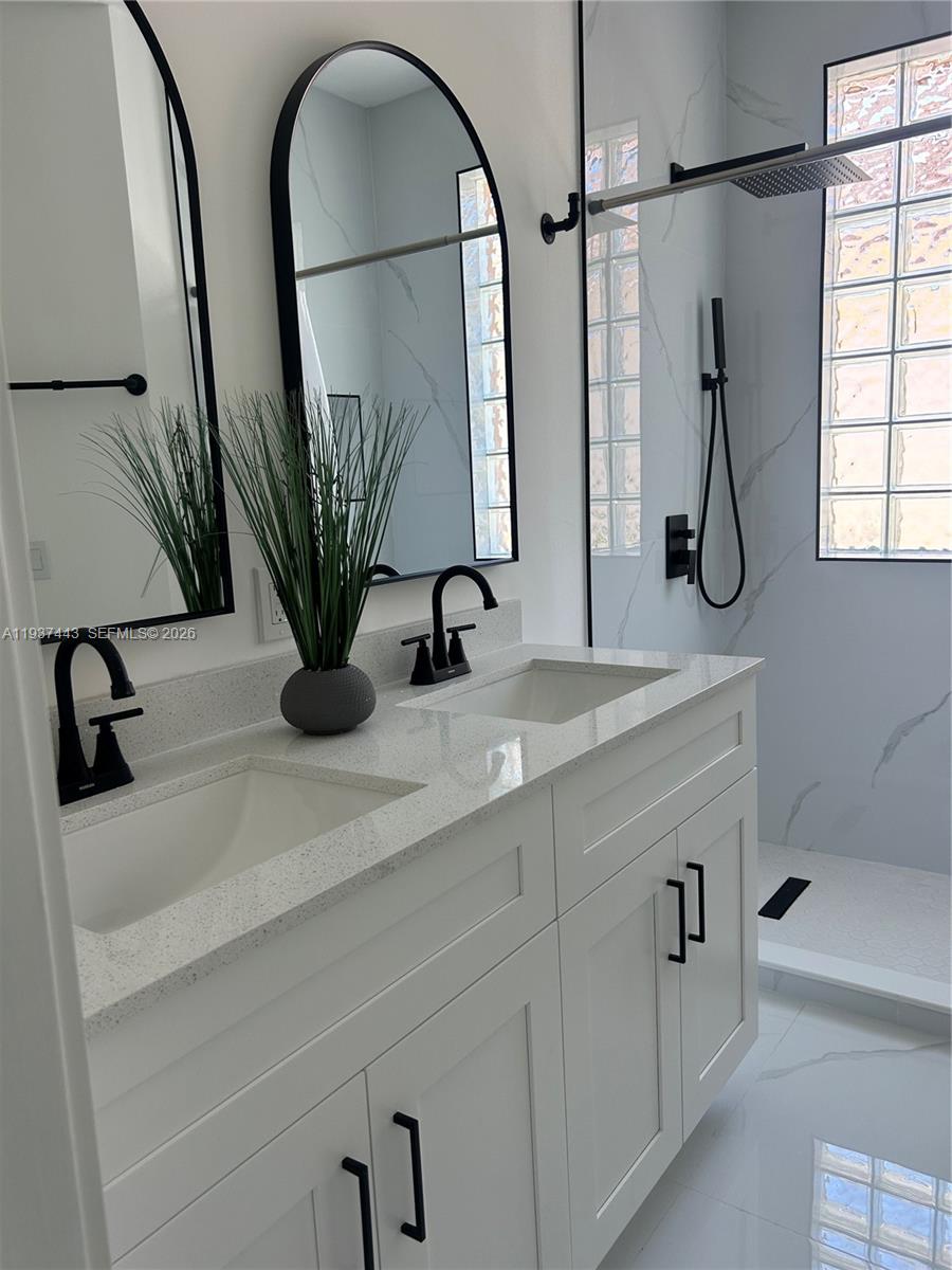 7729 Northwest 194th Terrace Hialeah, FL 33015 - Photo 16 of 21 a bathroom with sinks and a mirror