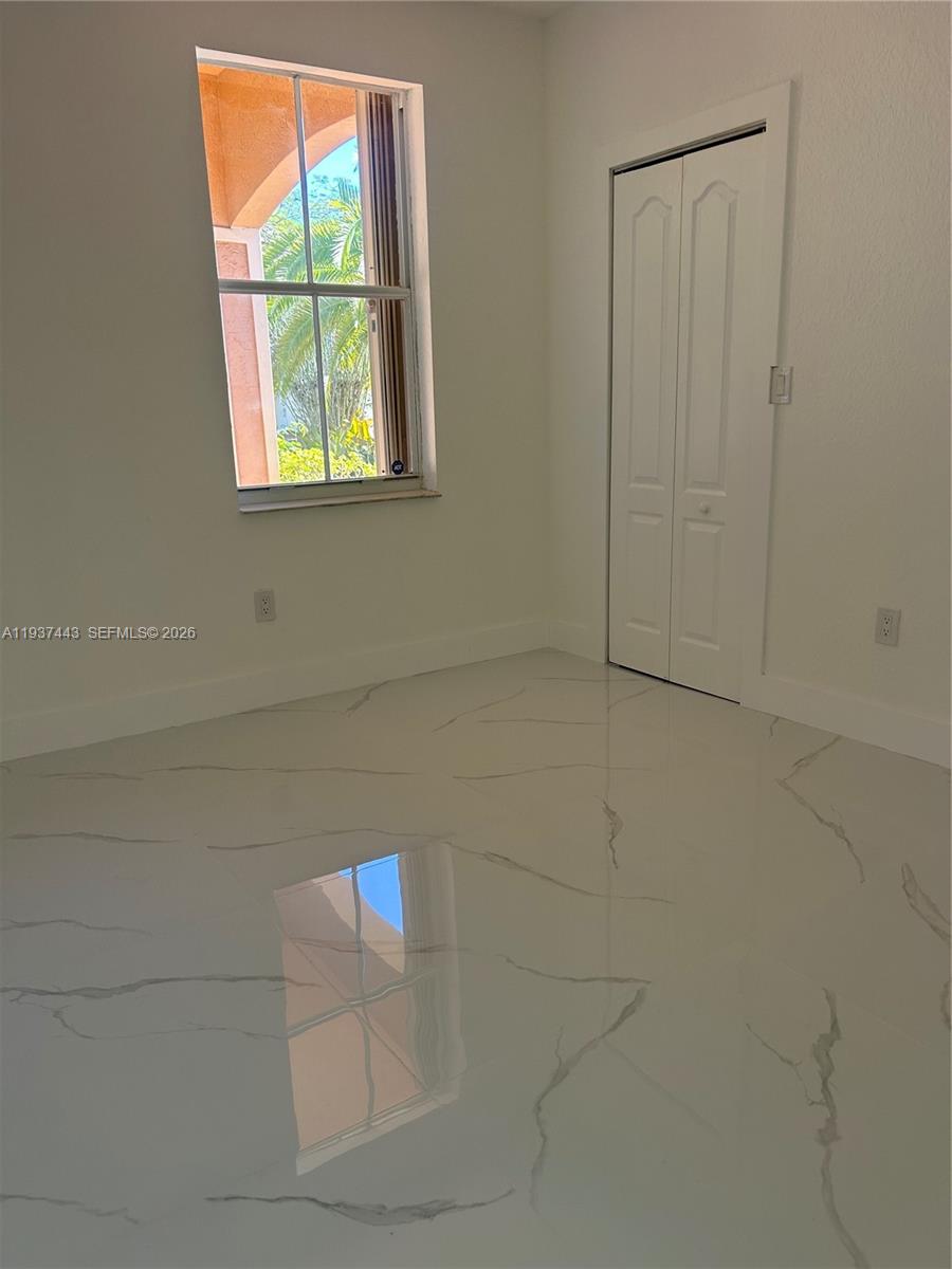 7729 Northwest 194th Terrace Hialeah, FL 33015 - Photo 19 of 21 a view of an empty room and window