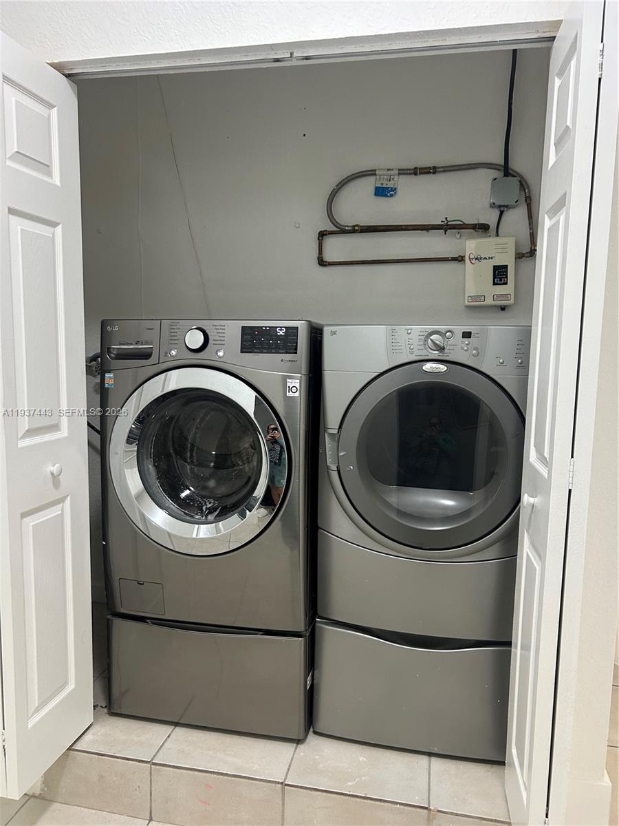 7729 Northwest 194th Terrace Hialeah, FL 33015 - Photo 21 of 21 a utility room with dryer and washer