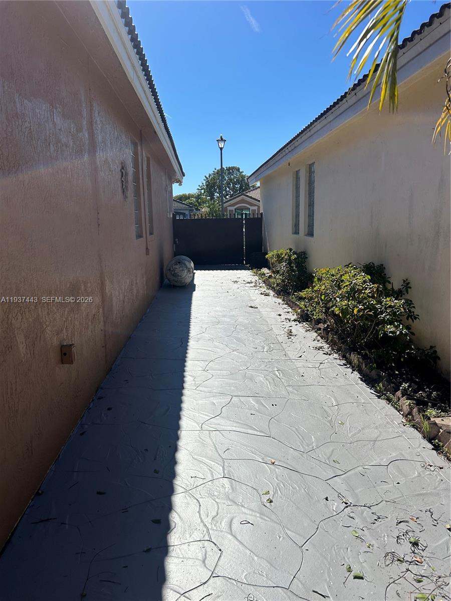 7729 Northwest 194th Terrace Hialeah, FL 33015 - Photo 4 of 21 a view of a backyard with potted plants