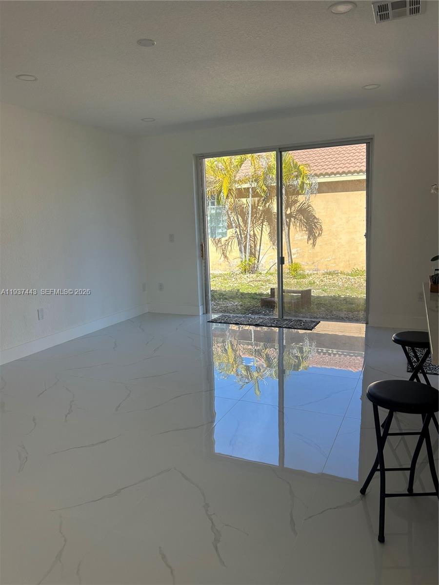 7729 Northwest 194th Terrace Hialeah, FL 33015 - Photo 10 of 21 a view of a livingroom with an outdoor space and seating