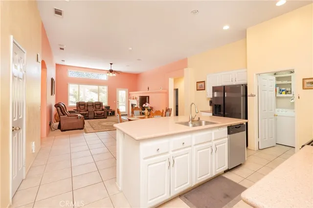 a kitchen with white cabinets and appliances