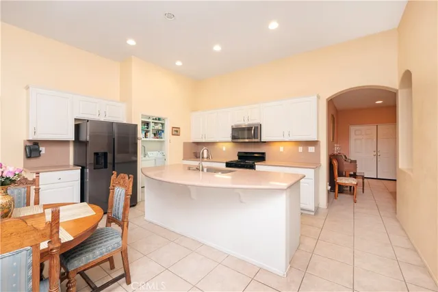 a dining room with furniture and a view of kitchen