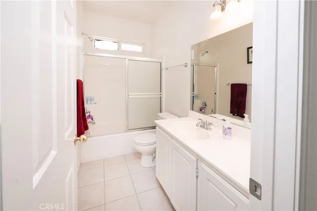 a bedroom with bed and a chair