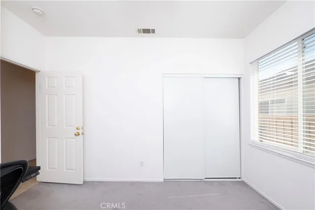a bed sitting in a room next to a window