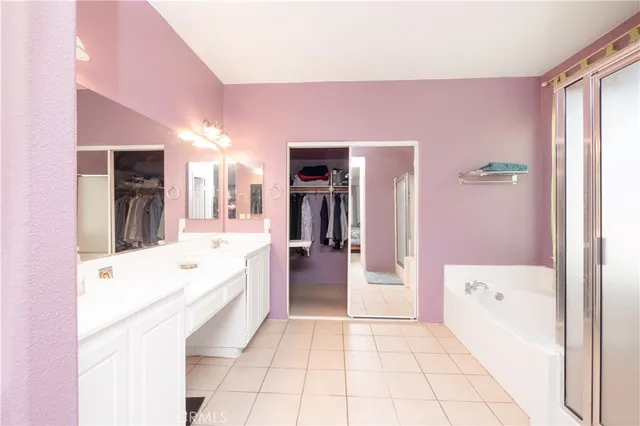 a bathroom with a bathtub a shower and a shower