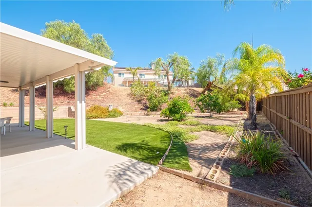 a view of a house with a yard and porch