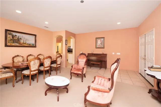 a large white kitchen with a large window and stainless steel appliances
