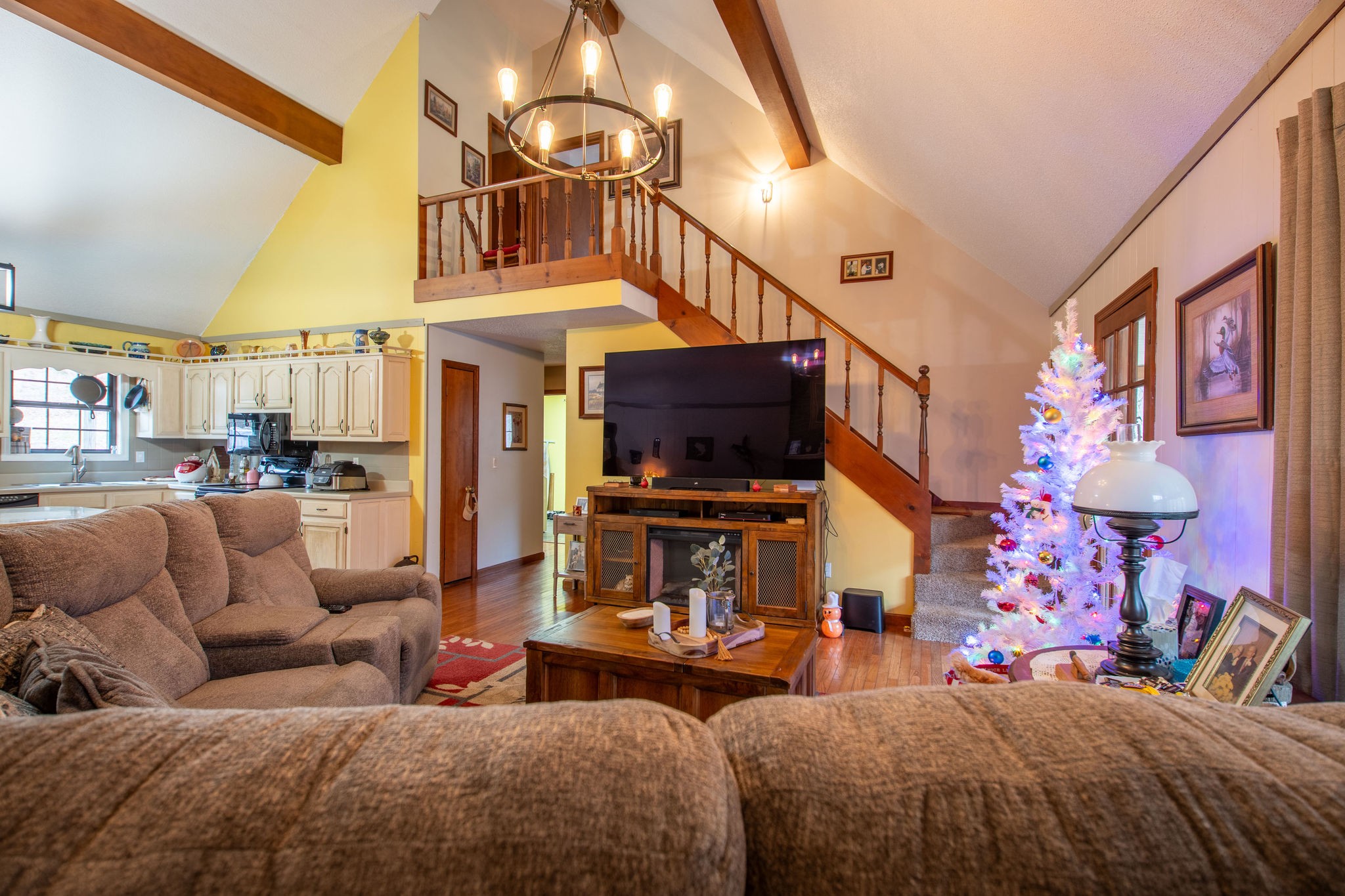 323 Spring Creek Road Lawrenceburg, TN 38464 - Photo 11 of 49 a living room with furniture a flat screen tv and a fireplace
