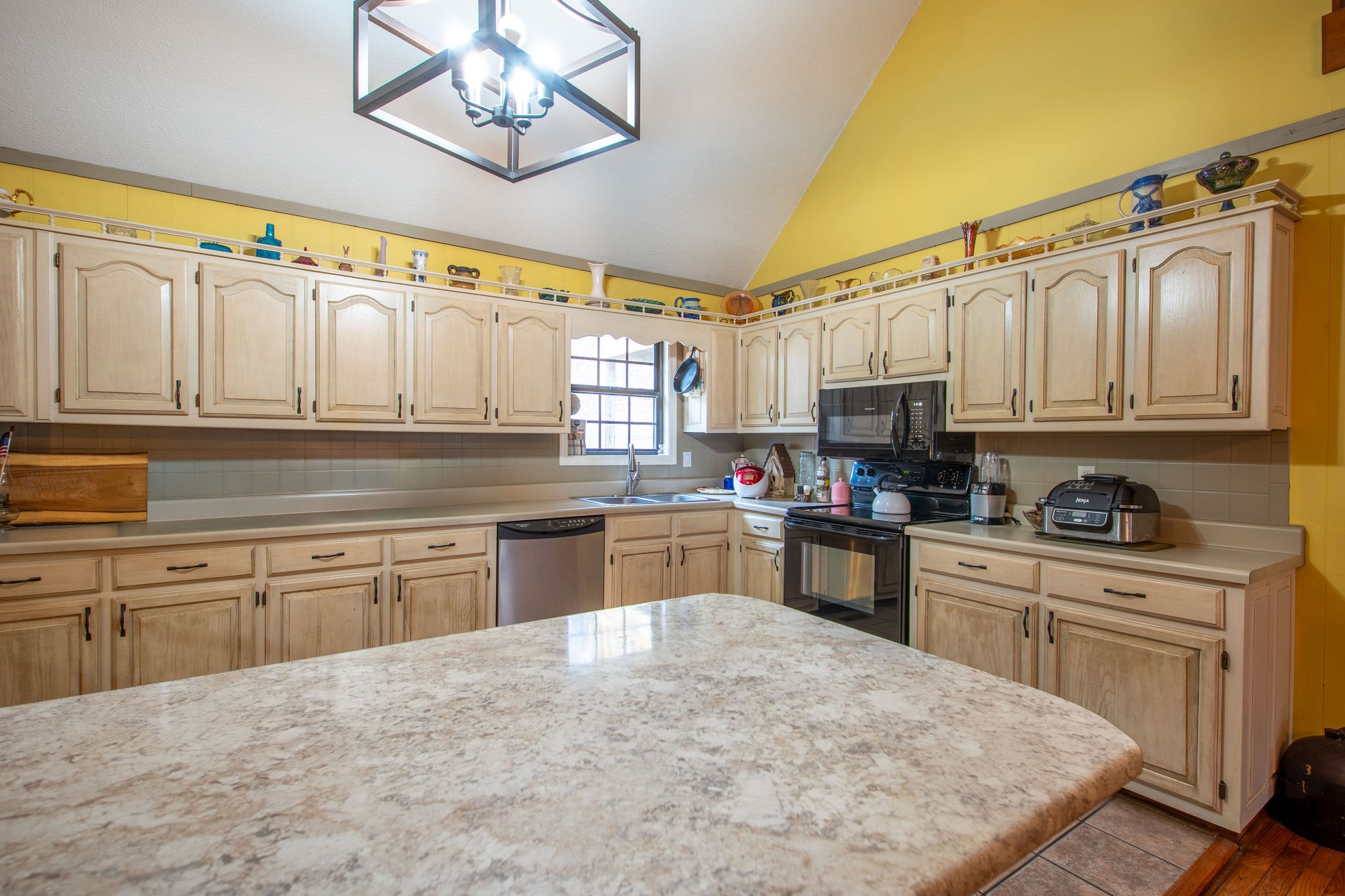323 Spring Creek Road Lawrenceburg, TN 38464 - Photo 15 of 49 a kitchen with stainless steel appliances granite countertop a stove sink and cabinets