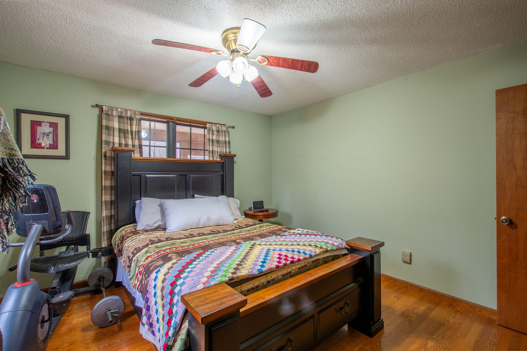 323 Spring Creek Road Lawrenceburg, TN 38464 - Photo 17 of 49 a bedroom with a bed and a chandelier