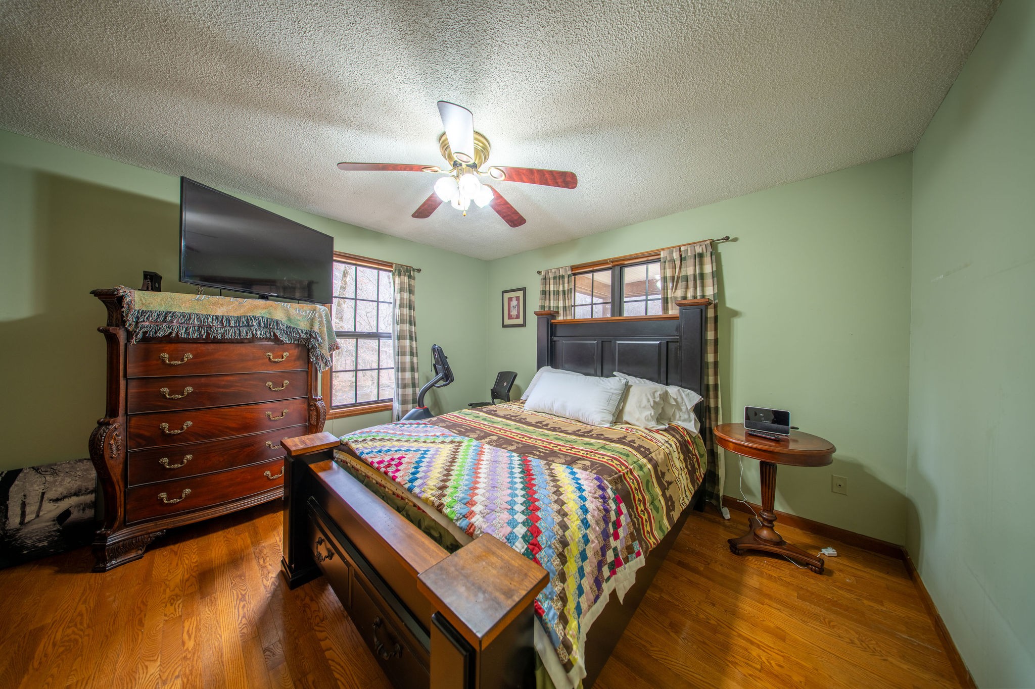 323 Spring Creek Road Lawrenceburg, TN 38464 - Photo 18 of 49 a bedroom with a bed and a chandelier