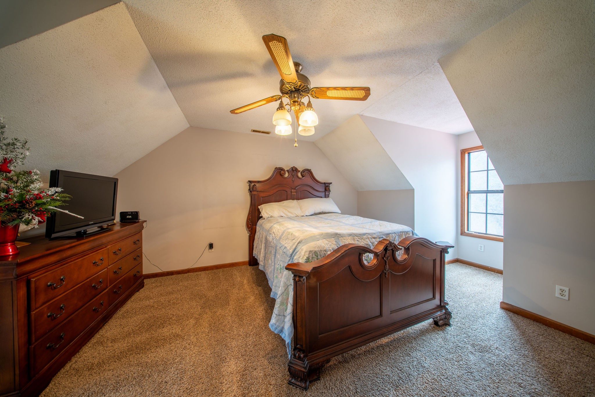 323 Spring Creek Road Lawrenceburg, TN 38464 - Photo 21 of 49 a bedroom with a bed and a chandelier