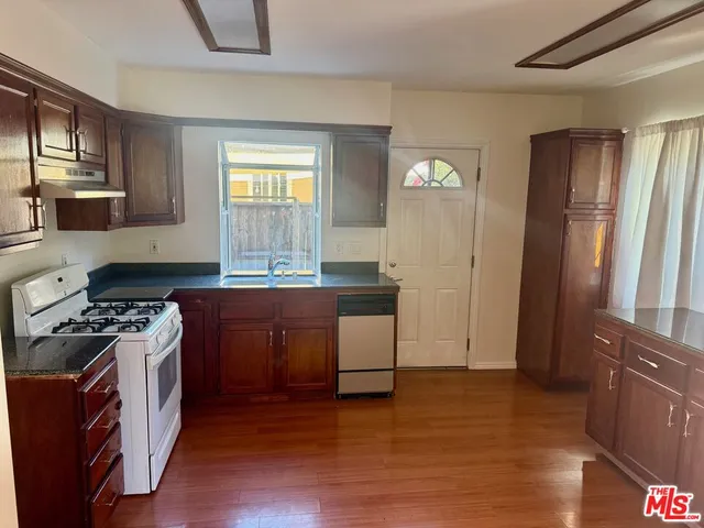 a kitchen with granite countertop a stove and a refrigerator
