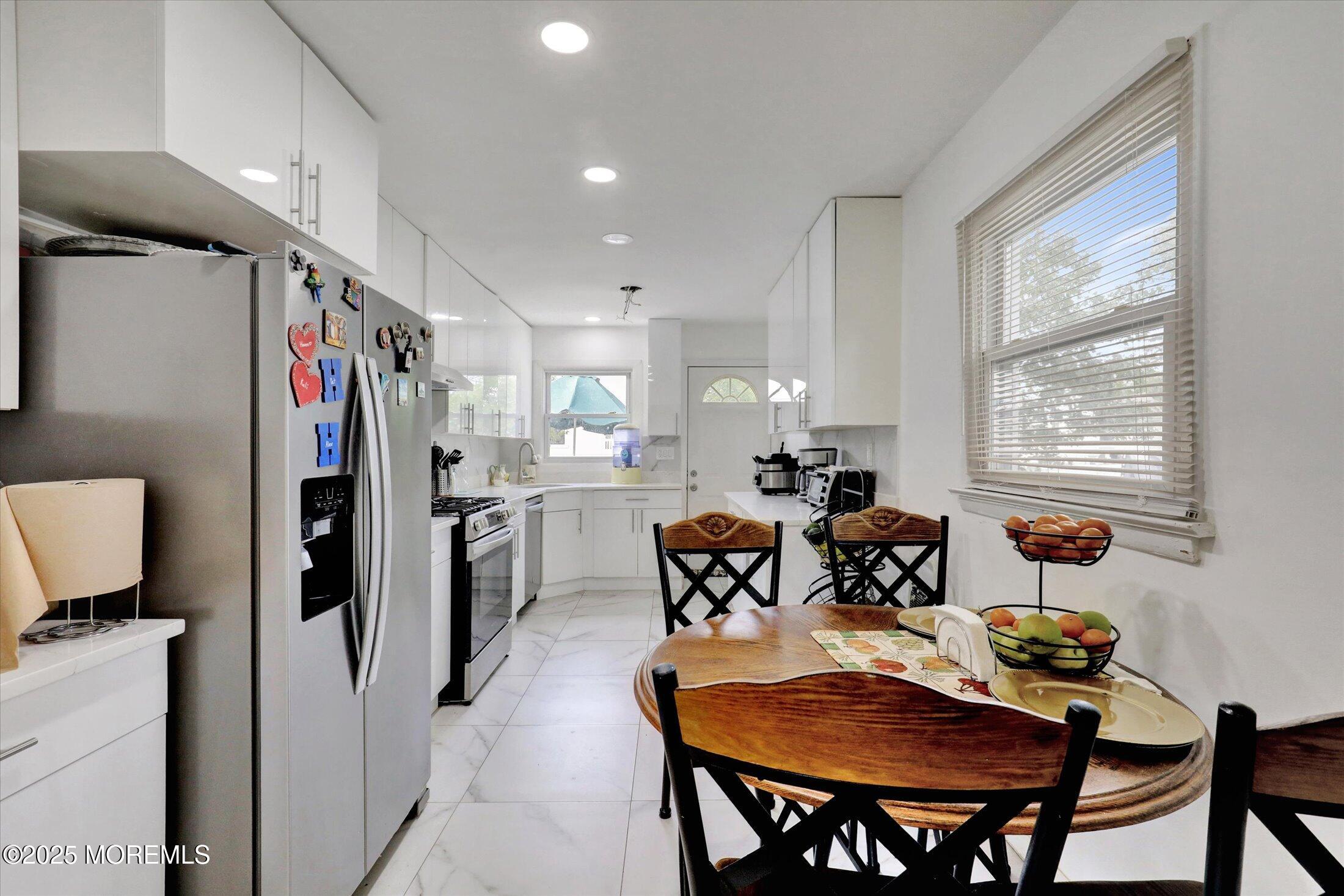 24 Berger Avenue Oakhurst, NJ 07755 - Photo 13 of 49 a outdoor dining space with furniture and window