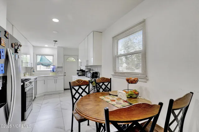 a view of a dining room with furniture and window