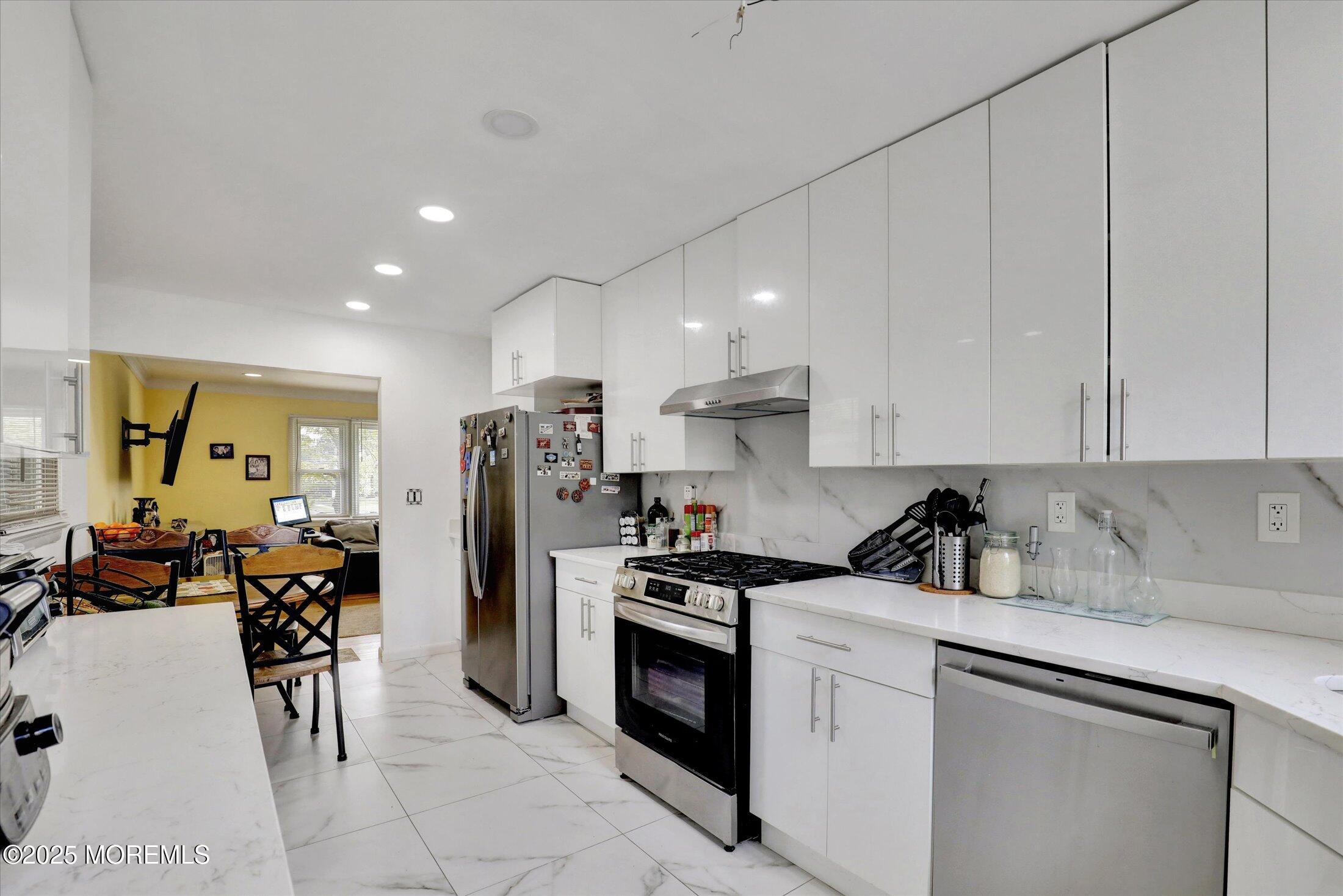 24 Berger Avenue Oakhurst, NJ 07755 - Photo 17 of 49 a kitchen that has a lot of cabinets a sink and appliances in it